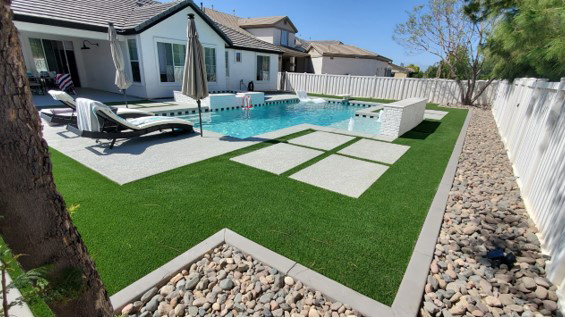 Beautiful backyard with trees and stone landscaping with brick wall seating.